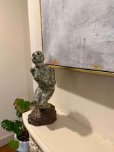 Cargar imagen en el visor de la galería, Small statue of a person on a mantle in front of an abstract painting