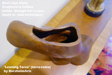 Laden Sie das Bild in den Galerie-Viewer, Terra-cotta hollow sculpture of a woman's torso sitting on a wooden table, view from the top (bird's eye View)