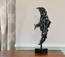 Load image into Gallery viewer, Diagonal view of a tabletop bronze sculpture on a dresser top.  Square granite base hosts the square stick that supports the bronze birds in Murmuration.
