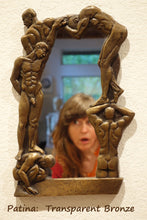 Carica l'immagine nel visualizzatore di Gallery, an asymmetrical frame of nude men for this small personal mirror.  shown here with the artist's face looking towards the nude men, patina is transparent bronze
