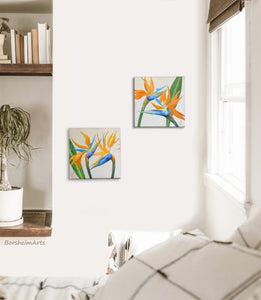Shown in a boho style bedroom are two floral paintings of bird of paradise flowers