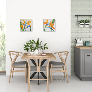 Pair of flower paintings brighten this dining room table setting, birds of paradise set of two floral paintings