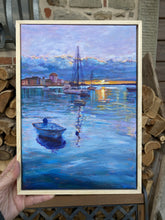 Laden Sie das Bild in den Galerie-Viewer, Framed painting of a harbor scene with boats and buildings.