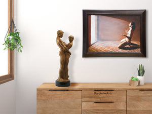 Left:  a bronze sculpture of an embracing couple stands on the dresser in this bedroom scene, while the framed oil painting "Relinquish" is shown on the wall to the right.  Both artworks are by artist Kelly Borsheim