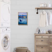 Laden Sie das Bild in den Galerie-Viewer, Laundry room with washing machine, dryer, and framed artwork of a harbor with boats and sunset on the wall.