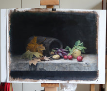 Laden Sie das Bild in den Galerie-Viewer, A still life oil painting on canvas depicting a dark barrel, autumn leaves, a purple artichoke, and potatoes on a stone ledge, displayed on an easel, before framing.