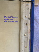 將圖片載入圖庫檢視器 Detail of back of wood frame showing the hook at wire at top of image, the Juhl-Larson brand blue wood frame, and the canvas wrapped around wooden stretcher bars inside the frame, secured with thumb tacks.