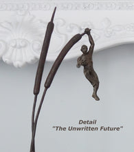 Load image into Gallery viewer, Detail of the roughly shaped small man hanging from one arm onto a relatively large cattail.