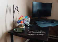 Load image into Gallery viewer, A teenage boy loves the bronze sculpture &quot;The Unwritten Future&quot; enough that he added it to his computer table where he loves to be a gamer.
