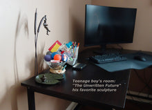 Load image into Gallery viewer, A teenage boy loves the bronze sculpture "The Unwritten Future" enough that he added it to his computer table where he loves to be a gamer.