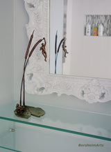 Load image into Gallery viewer, Another modern bathroom shot with the tabletop bronze sculpture of two small male figures and nature.
