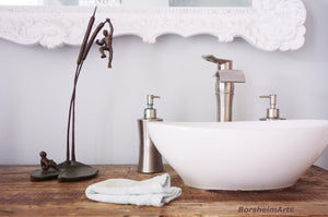 Original bronze sculpture enhances this elegant and modern rustic bathroom seen.
