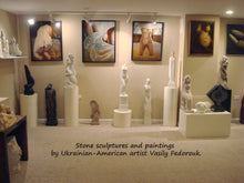 Charger l'image dans la galerie, Photo by artist Kelly Borsheim of the studio of sculptor Vasily Fedorouk.  It showcases many of his female figures in sculptures carved in stone, as well as paintings of his wife on the wall above the 3-d art.