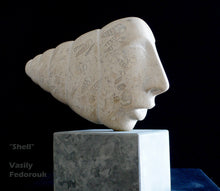 將圖片載入圖庫檢視器 Artistic sculpture of a face made a stone, with the head carved into a shell on a dark background, marble base