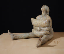 將圖片載入圖庫檢視器 Ceramic sculpture of a seated figure looking to the heavens with legs extended on a beige surface with a black background