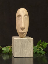 將圖片載入圖庫檢視器 Creme-colored stone face sculpture (front view) on a square marble base with green leaves in the background for size comparison