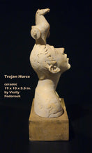 Carica l'immagine nel visualizzatore di Gallery, Ceramic sculpture of a boy looking up at Trojan Horse on his head on a black background. Portrait of the artist's son.