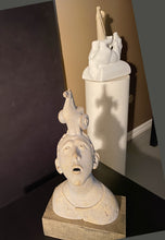 Carica l'immagine nel visualizzatore di Gallery, Front view of ceramic portrait sculpture of a boy looking up wondering what is the Trojan Horse resting on his head. In the background is a stone sculpture of another man and horse by the same artist, Vasily Fedorouk.
