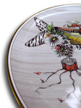 Load image into Gallery viewer, Detail of collector designer plate quality Miss Mushroom This fantasy drawing printed onto a porcelain and gold plate features the high-heeled shoe of Miss Mushroom (see top of shoe) and she is sure to delight!  Do you see red lips with tails, a serpent or snake, butterfly wings, zebra stripes, leopard design, tiny shoes, a bouquet of flowers, especially daisies, bats, and a spider web?
