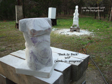 Load image into Gallery viewer, Here you see the sculpture Back to Back during the carving process, as artist Kelly Borsheim draws directly on the marble the anatomy of the female nude torso.  Behind and to the right in another marble sculpture work in progress, the much larger garden sculpture Gymnast
