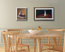 Carica l'immagine nel visualizzatore di Gallery, dining room in sea foam green and natural wood table and chairs help put the focus on these two paintings of Italian food specialties, wine, cheese, olives and olive oil.  Both framed paintings are by artist Kelly Borsheim