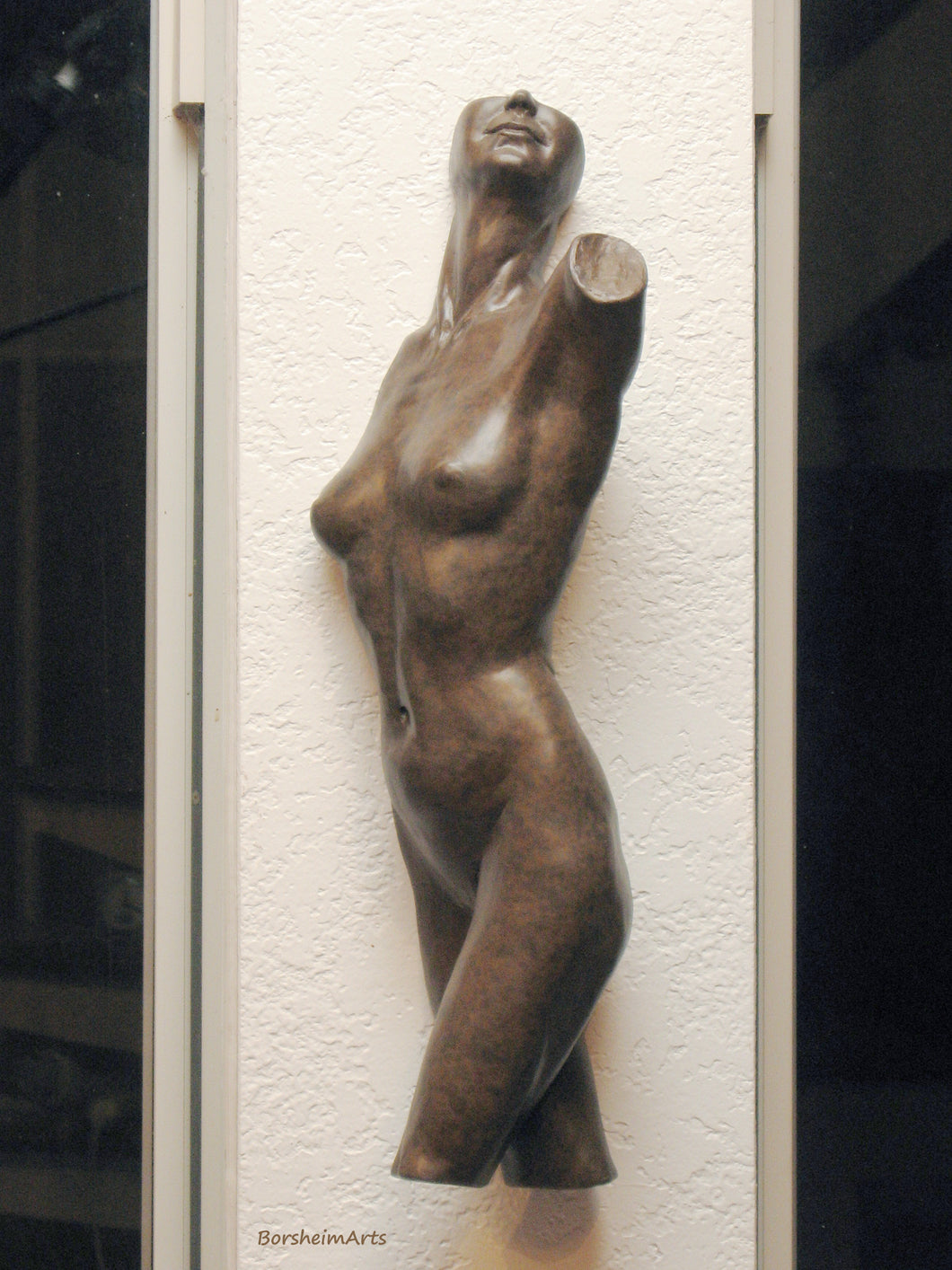 Tucking a little bronze wall art nude in the support wall between a house full of windows.  Great wall-mounted bronze figure for narrow walls.