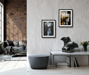 Framed prints of couples walking in the rain on the cobblestone streets of Firenze, Italia (Florence, Italy) shown here hung framed at different heights, stone sculpture Encouter sitting on the coffee table below in a lovely loft apartment