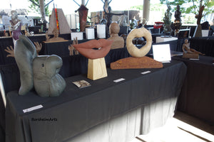 Fish Lips is shown here at a sculpture show in Little Rock, Arkansas, with two other stone carvings in the Lips Series of sculpture, Lip Service and Mobius Lips (sold)..bronze Eric is also in the image.