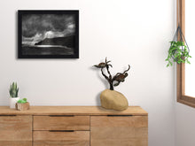 將圖片載入圖庫檢視器 16 inch tall sculpture of Sea Turtles swimming in kelp enhances this bedroom chest of drawers.  Above it is a framed print of another ocean or sea inspired work, the print of charcoal drawing Spotlight. Sculpture is a limited edition bronze and stone (each limestone base is hand carved). 3-d Art by Kelly Borsheim