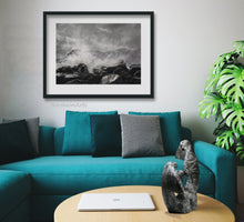 Load image into Gallery viewer, Mock up image of how you could frame the original seascape drawing Splash in a living room with a teal couch.  The same artist Kelly Borsheim carved the stone sculpture Encounter that is displayed on the coffee table.
