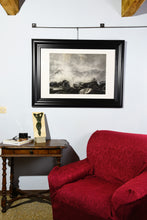 Load image into Gallery viewer, Original drawing Splash, crashing waves on dark rocks is shown hung on a wall in a country home, with the small bronze bas relief Ten, also available from artist Kelly Borsheim
