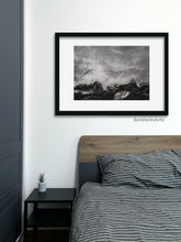 Load image into Gallery viewer, Shown here is the charcoal and pastel drawing Splash, inspired by the Cinque Terre in Italy, framed with a wide white mat and thin black line frame.  The art is hung in a man&#39;s bedroom.
