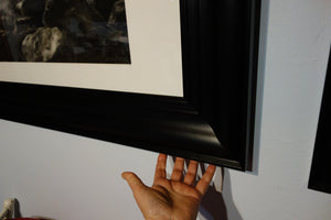 Another frame detail with the artist's hand to show dimensions.