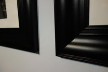 Load image into Gallery viewer, Detail of the black plastic frames from IKEA.  Change after safe shipping or keep and hang instantly.
