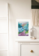 Load image into Gallery viewer, Tuscan Road in Shadows Pastel Art shown with white frame and white mat.  The art rests against a wall as it sits on the top of a dresser in this boho bedroom scene.
