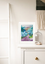 Cargar imagen en el visor de la galería, Tuscan Road in Shadows Pastel Art shown with white frame and white mat.  The art rests against a wall as it sits on the top of a dresser in this boho bedroom scene.