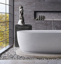 Load image into Gallery viewer, Born from Stone is a female nude stone carving in granite that looks quite as home in this luxury bathroom with a view.

