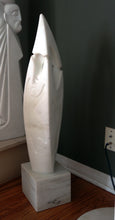Load image into Gallery viewer, Another view of the marble sculpture of a flame with subtle figures drawn into the stone.  Birth of Beauty in part is seen in the background.  Contemporary sculpture by Vasily Fedorouk.