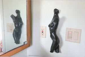 Here the Dancer bronze nude torso of a ballerina is shown hung on a bathroom wall and reflected in the mirror for double enjoyment.  Patina is the dark green finish here.