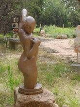 Laden Sie das Bild in den Galerie-Viewer, View of the face that looks down to the female figure's right side. Gemini Bronze Garden Sculpture Voluptuous Abstract Figure Statue with Two Faces shown in a sculpture garden in Dripping Springs, Texas