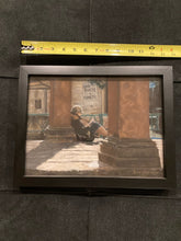 Laden Sie das Bild in den Galerie-Viewer, Here you see a tape measure alongside the framed art.  This is intended to give you a much better idea about the size of this pastel drawing of a young woman sitting outside in, leaning against Italian square columns in a piazza in Florence, Italy.  She is reading a book, relaxing in the winter sunshine.  Pastel art by Kelly Borsheim