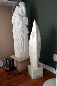 Shown here in a living room to show actual size is Birth of Beauty, three human figures in marble.  Beside that artwork is "Fire Dance," a lovely flame-shaped white marble sculpture with bas-relief figures by Vasily Fedorouk