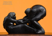 Load image into Gallery viewer, Profile Helping Hands by Kelly Borsheim Couple Art Carved from a black marble with subtle white stone inclusions or thin veins, this sculpture depicts a man bending over forward to help a seated woman stand up. Her hands reach up towards his bearded face, but it is the moment before she is close enough to reach him. Orange background.