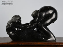Load image into Gallery viewer, Helping Hands by Kelly Borsheim Couple Art Carved from a black marble called Bardiglio from Italy, this sculpture depicts a man bending over forward to help a seated woman stand up.  Her hands reach up towards his bearded face, but it is the moment before she is close enough to reach him. 
