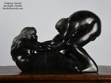 Load image into Gallery viewer, Helping Hands by Kelly Borsheim Couple Art Carved from a black marble called Marquina from Basque Country, Spain, this sculpture depicts a man bending over forward to help a seated woman stand up.  Woman is shown on the right.  Her hands reach up towards his bearded face, but it is the moment before she is close enough to reach him.