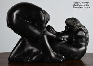 note the space between the woman's hand and his face Helping Hands by Kelly Borsheim Couple Art Carved from a black marble called Bardiglio from Italy, this sculpture depicts a man bending over forward to help a seated woman stand up.  Her hands reach up towards his bearded face, but it is the moment before she is close enough to reach him. 