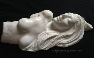 white marble portrait including nude upper torso sculpture of a woman with long flowing hair by Japanese artist Kumiko Suzuki