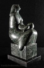 Load image into Gallery viewer, Green marble tabletop sculpture of a mother with a squirming child on her lap looks upwards to God, art by Vasily Fedorouk