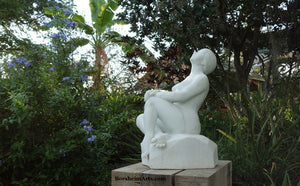 Stargazer Garden Marble Sculpture of seated Woman resting hands on a knee while leaning back to look up to the skies and stars.