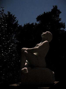 Moonlit Stargazer Garden Marble Sculpture of seated Woman resting hands on a knee while leaning back to look up to the skies and stars.